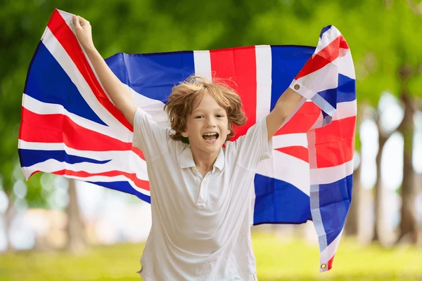 A child proudly holds a union jack flag to represent team GB.