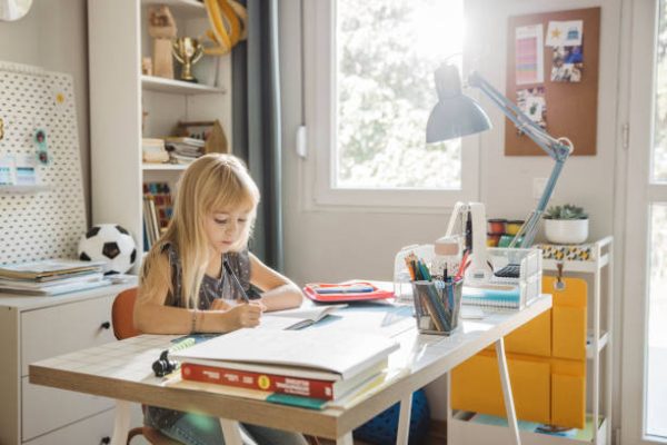Girl working on her homework at home.
