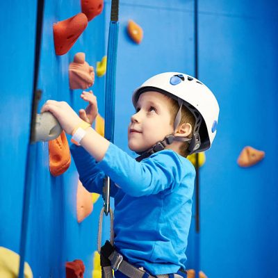 Child Climbing a climbing frame on a wall