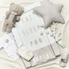 This easy-to-clean changing mat has a soft foam inside and high sides to keep your baby safe and comfy during changes. The plastic cover makes cleaning super simple. It has a nice Eat, Sleep, Repeat design. A safe, comfy, and clean spot for changing your baby. Soft foam with raised sides. Easy-to-clean plastic cover. Stylish Eat, Sleep, Repeat pattern.