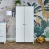 The Pensham double wardrobe offers ample storage with a double rail. Its design, featuring a traditional finish, stunning natural wood, and attractive brass handled doors, does not compromise on aesthetics. The spacious cupboard includes two hanging rails and a single full-width shelf, perfect for storing all your baby's clothes.
