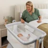 The first months with your baby are special but can be a lot, especially with sleep. That's why the Cloud bedside crib is here. It's made to help with nighttime. This comfy crib lets you keep your baby close for feeding, hugging, and feeling calm. It also gives them a safe and cozy place to sleep. With its soft grey cloth, airy materials, and adjustable parts, it looks good in your home and helps you and your baby get more rest.