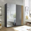 Upgrade your bedroom with this stylish and practical sliding door wardrobe. Its space-saving design features a full-length mirrored door, adding elegance and making the room appear larger and brighter. The smooth sliding mechanism allows easy access to your belongings while saving floor space. This wardrobe has a modern design with a trendy panel effect print on the door, adding dimension and style to your room. It's also easy to clean. The full-length mirrored door is functional, creating the illusion of more space in smaller rooms and allowing you to check your appearance before leaving. Inside, you'll find a well-organized layout with plenty of hanging space and sturdy shelves to keep your clothes and accessories neatly stored.