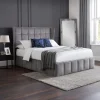 Meet the Lombok Ottoman Bed, a beautiful and practical bed. Its fancy winged headboard makes your bedroom look elegant. Underneath, the ottoman storage is great for keeping things tidy. It's covered in soft grey velvet, making it look and feel luxurious. The detailed headboard makes it a stylish focal point that's both grand and useful.
